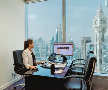 Prestigious serviced offices in Emirates Towers, Dubai were a women is finishing her work.