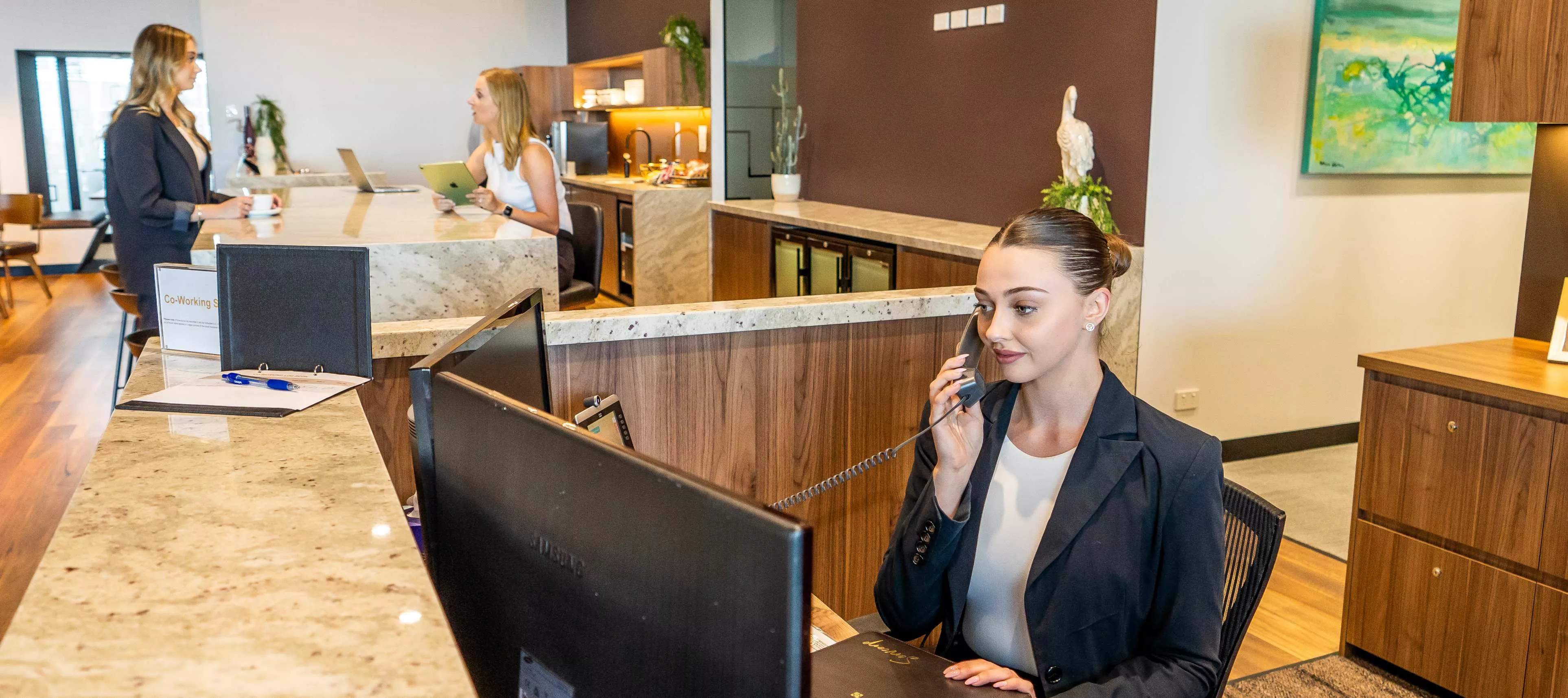Professional support at every touchpoint—Servcorp’s reception team in action.