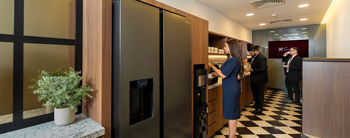 Fully stocked kitchen in Emirates Towers, Dubai, were people are getting some refreshments 