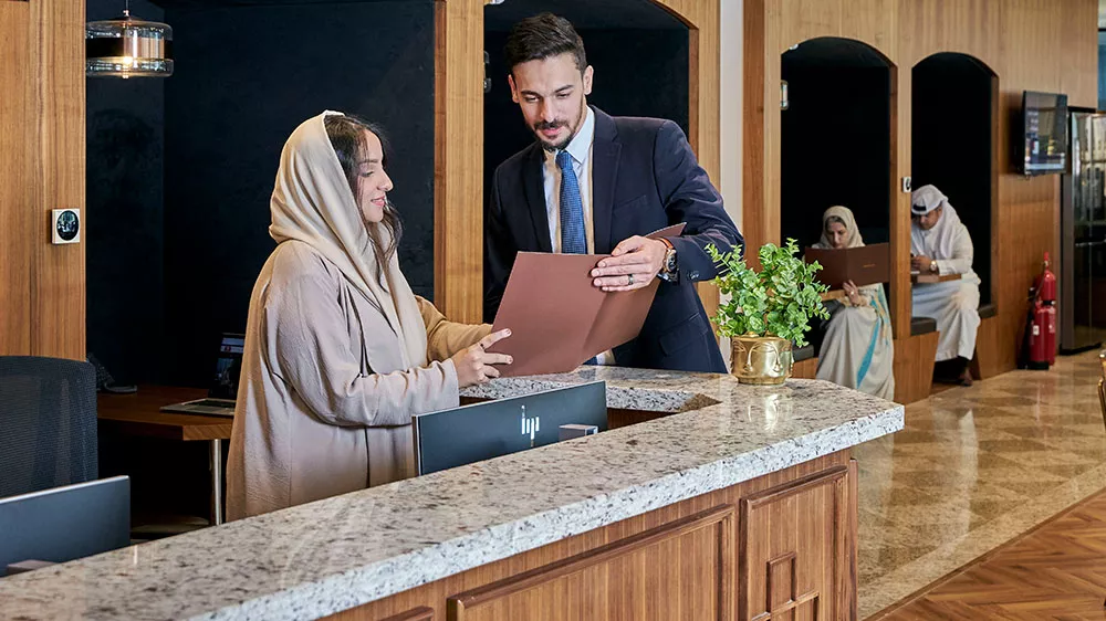 Team members collaborate at the front desk of a Servcorp coworking space in Saudi Arabia, blending professionalism with premium service.